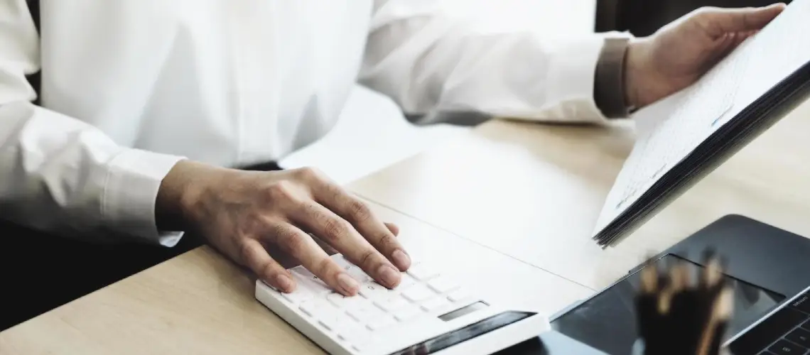 Australian financial documents and calculator representing business valuation for property investors